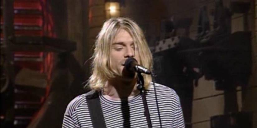 Kurt Cobain sings into a microphone as Nirvana perform on Saturday Night Live. 