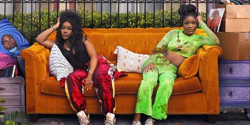 Keke Palmer and SZA in One of Them Days sitting on a couch out on the curb