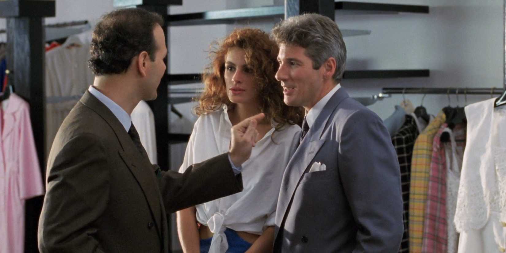 Vivian (Julia Roberts) and Edward (Richard Gere) talk to a clothing store employee in 'Pretty Woman'.