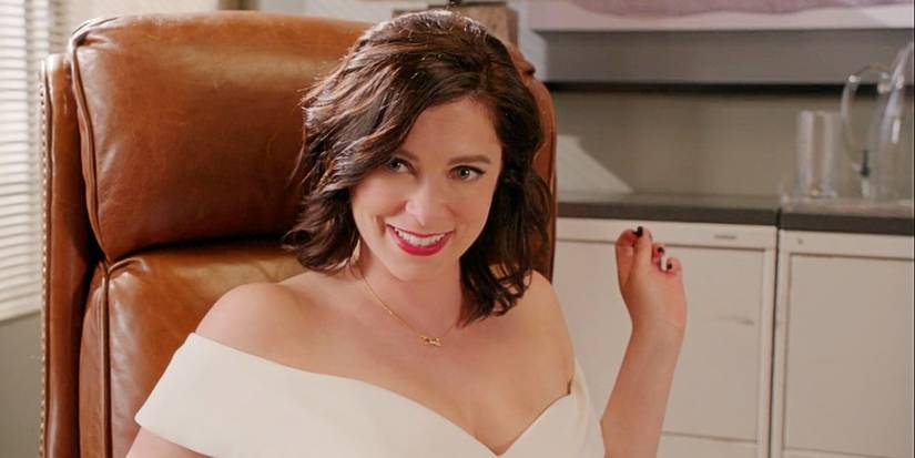 Rebecca Bunch sitting in an office chair in her wedding dress in Crazy Ex-Girlfriend Season 3.