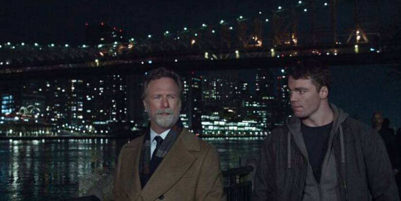 Louis Herthum standing near the Brooklyn Bridge with Gabriel Basso as Peter Sutherland in Season 2 of 'The Night Agent'