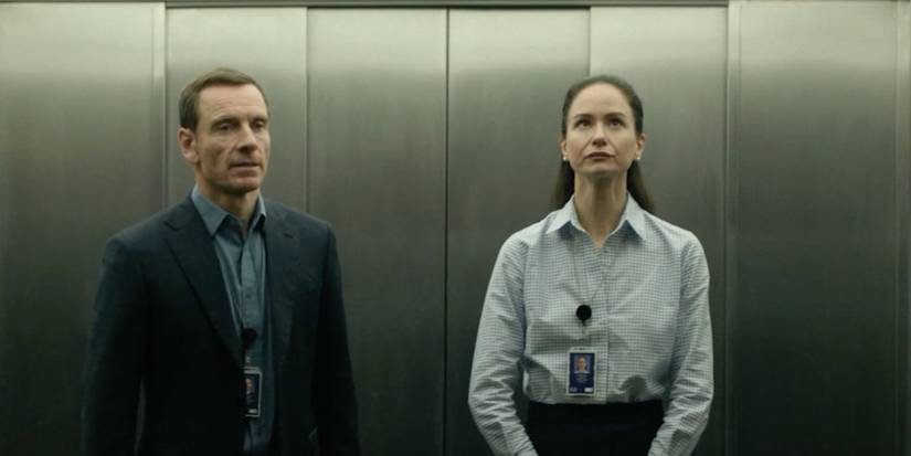 Michael Fassbender as Martian and Katherine Waterston as Naomi in the elevator in 'The Agency'