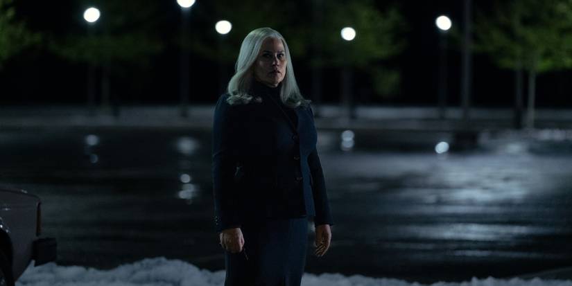 Patricia Arquette standing in the darkened parking lot of Lumon
