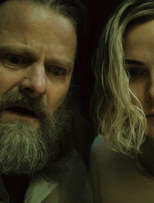 Steve Zahn and Rebecca Ferguson look concerned at something off-camera in the Silo Season 2 finale.