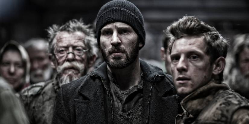 Chris Evans, Jamie Bell & John Hurt in a crowd looking ahead and feeling anxious in Snowpiercer.
