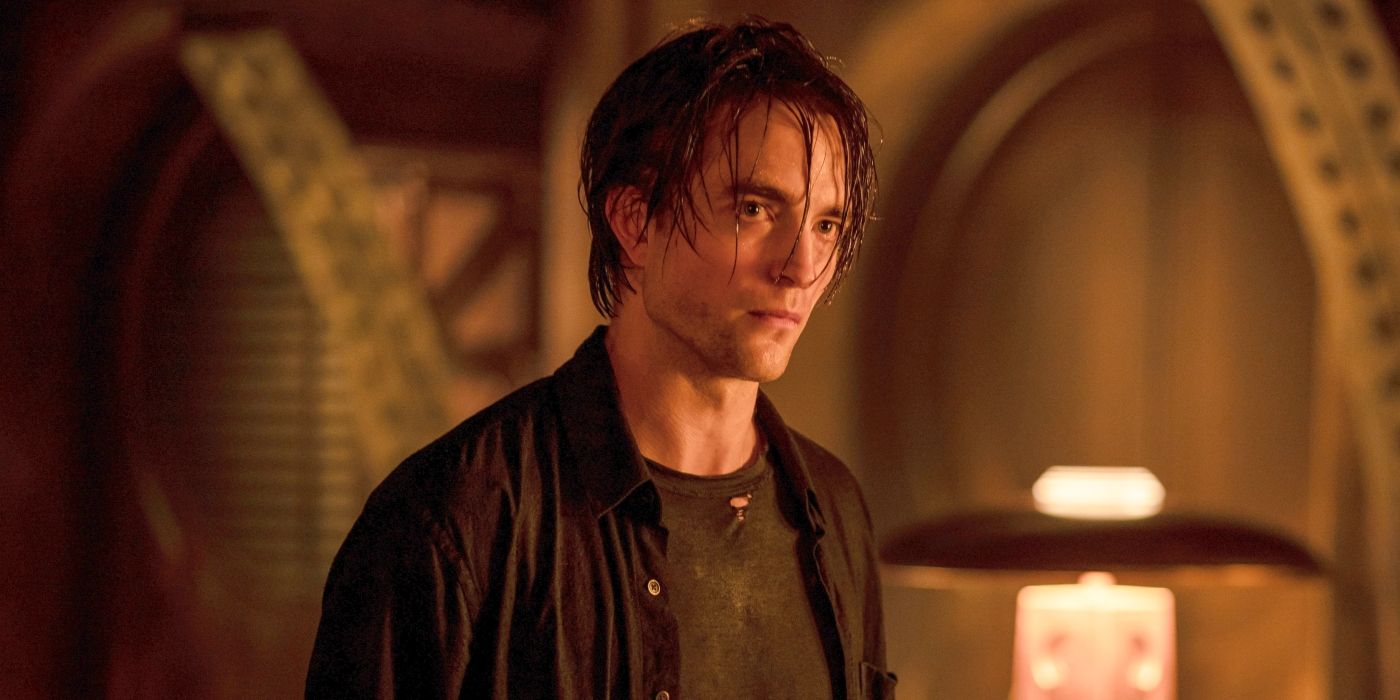 Robert Pattinson as Bruce Wayne with stringy hair in the batcave in The Batman