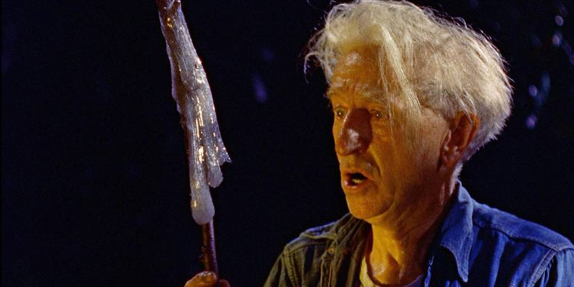 An old man holds up a stick with the blob on it in 'The Blob'