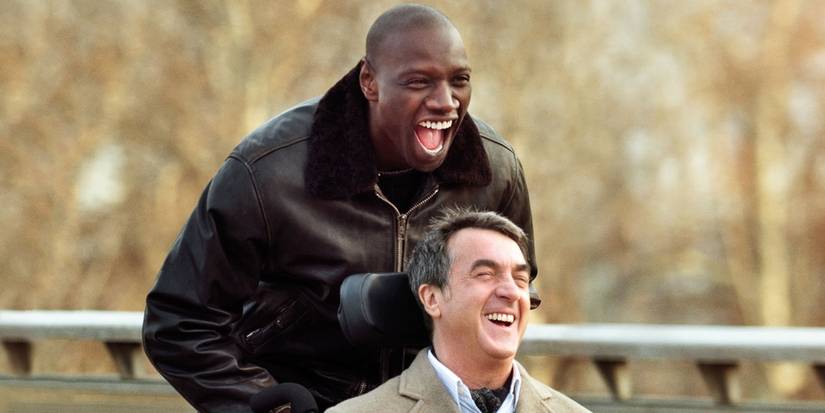 Omar Sy as Driss pushing François Cluzet as Philipp's wheelchair in The Intouchables