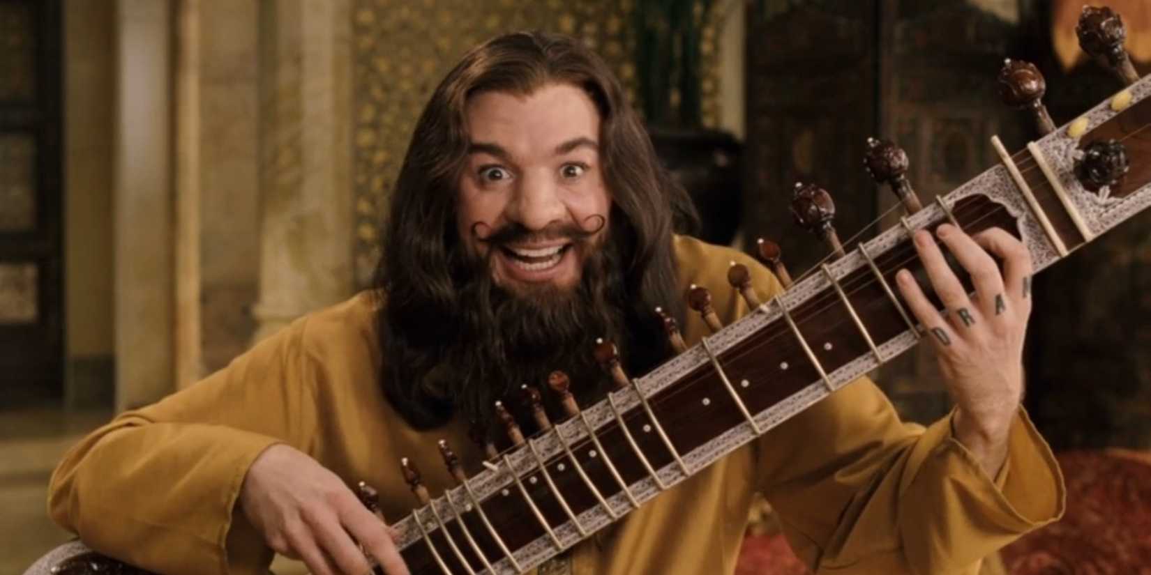 Guru Maurice Pitka, played by Mike Myers, holds a sitar in 'The Love Guru'.