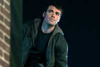 Gabriel Basso as Peter Sutherland outside next to a brick wall in Season 2 of The Night Agent