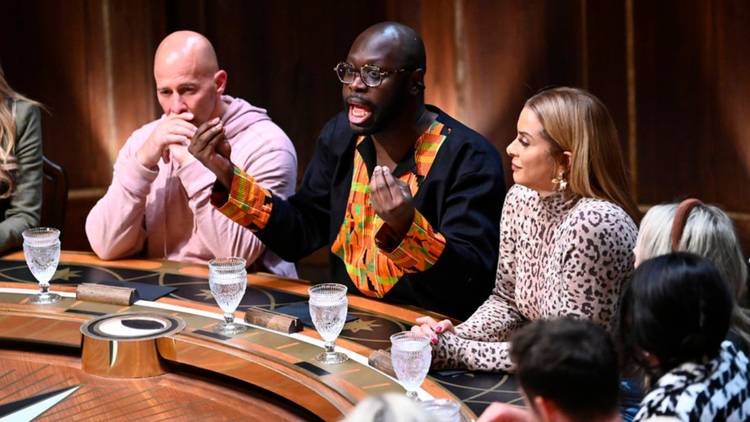 Bob the Drag Queen goes off as Tony Vlachos and Robyn Dixon listen at the Roundtable on 'The Traitors'