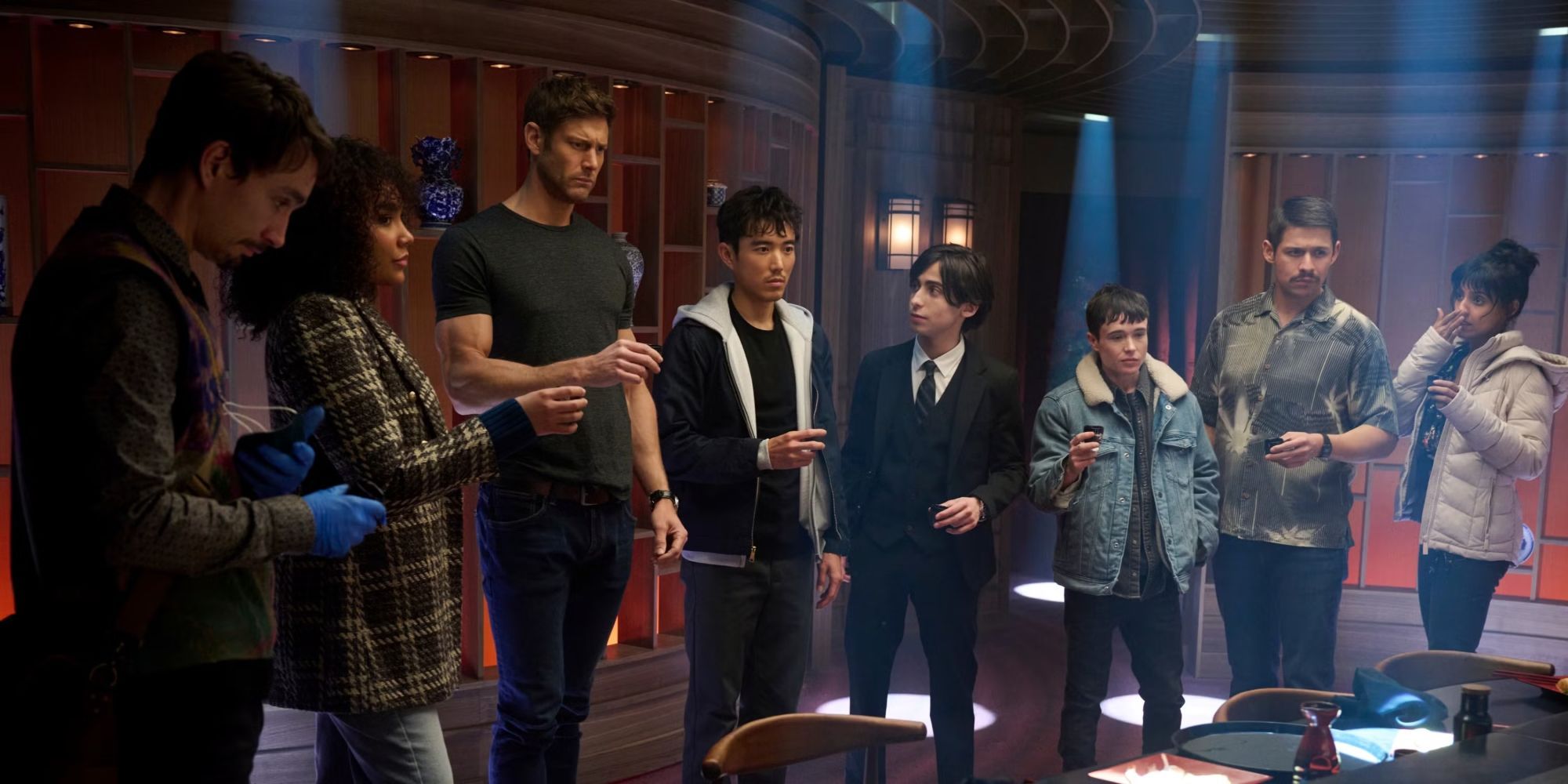 Emmy Raver-Lampman, Tom Hopper, Elliot Page and the cast holding shot glasses in The Umbrella Academy.