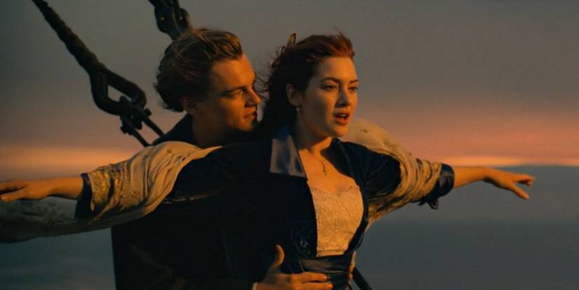 Leonardo DiCaprio as Jack holds Kate Winslet as Rose on the bow of the ship in Titanic.
