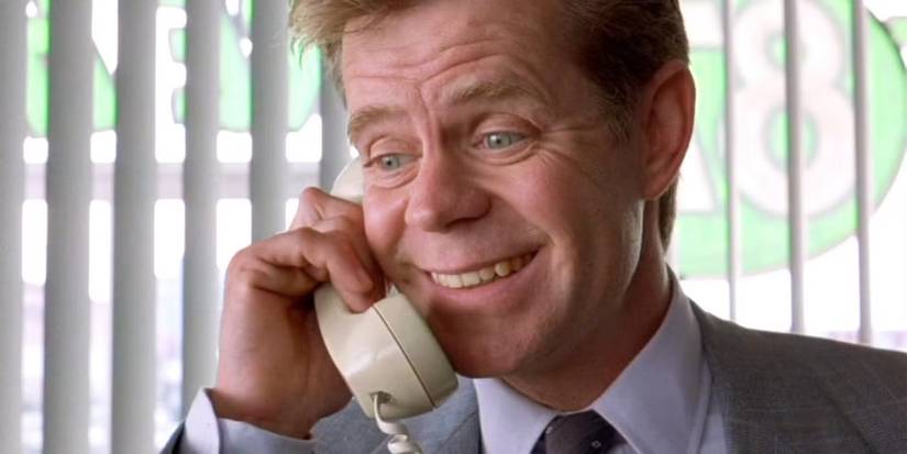 Jerry Lundegaard (William H. Macy), smiling desperately while on the phone in Fargo