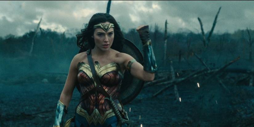 Wonder Woman, played by Gal Gadot, blocks a projectile with her bracer in Wonder Woman.