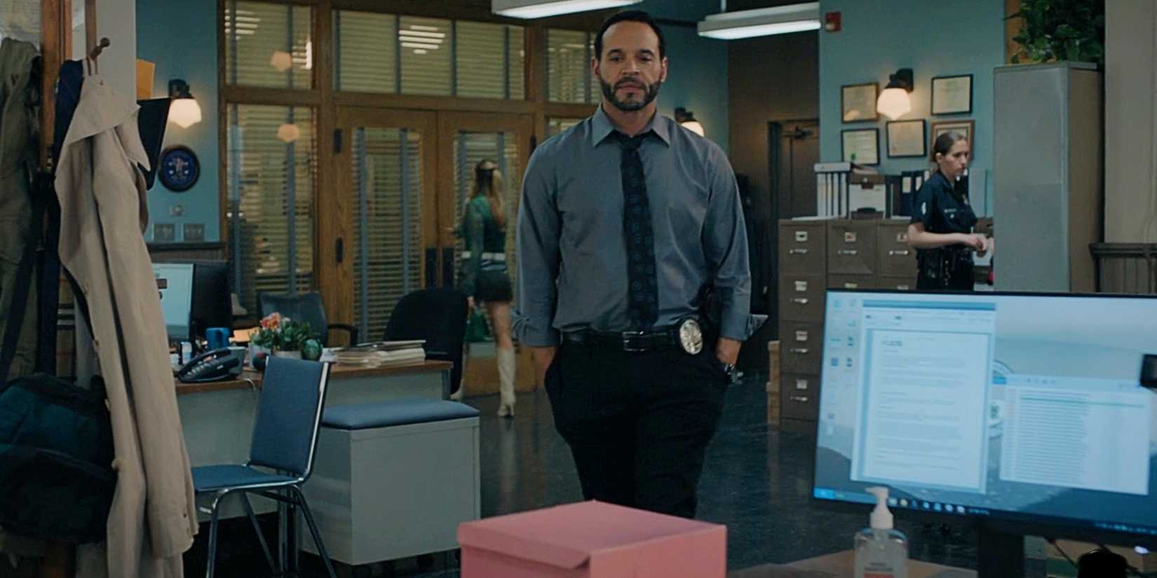 Karadec looking at a pink box on his desk in High Potential Season 1.