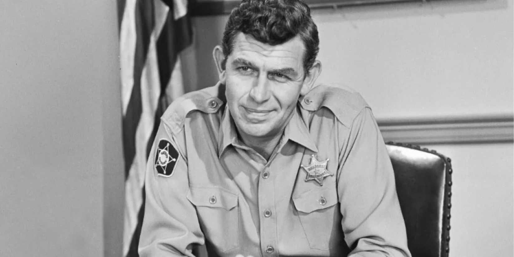 Andy Griffith as Andy Taylor, smiling, wearing a sheriff's uniform in The Andy Griffith Show.