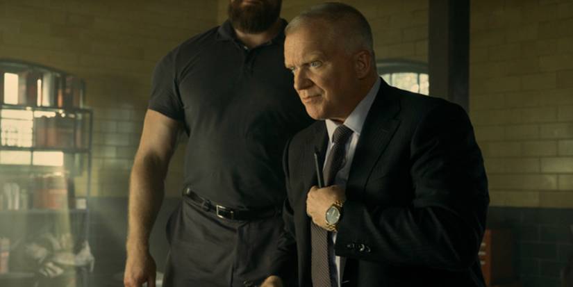 Anthony Michael Hall, holding his tie, as Zachary Beck in Reacher Season 3.