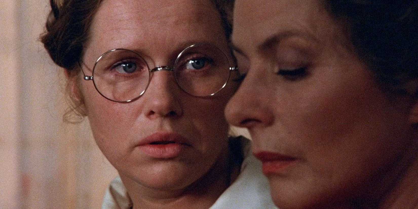 Liv Ullmann wears glasses and stares at Ingrid Bergman at her side in Autumn Sonata.
