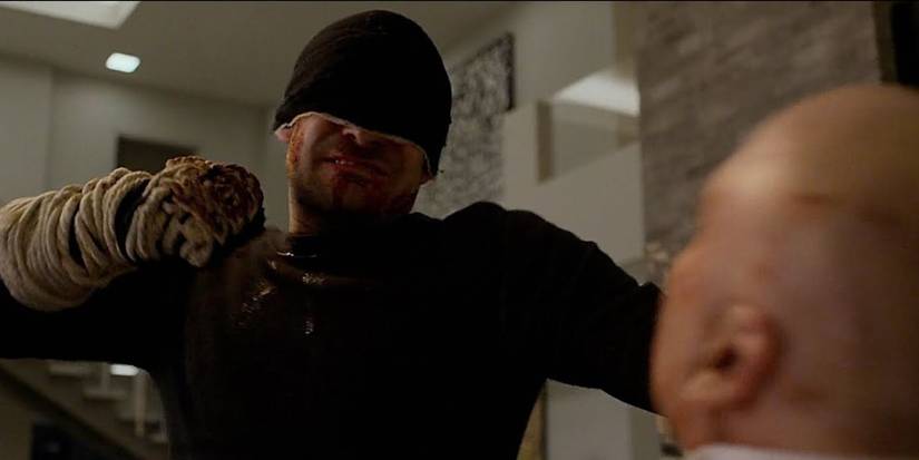 Daredevil with a bloody fist punching Kingpin in "A New Napkin" from Daredevil.