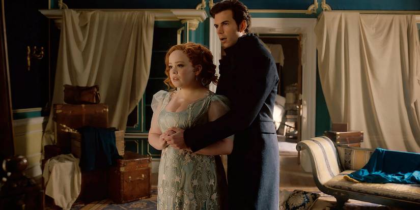 Penelope and Colin stand together in front of a mirror in Bridgerton.