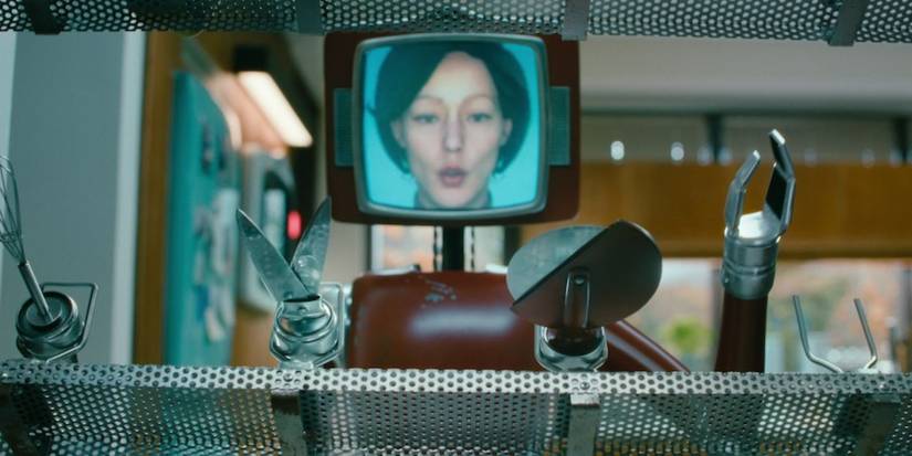 the Cassandra bot whistles as she looks over her many sharp kitchen attachment tools