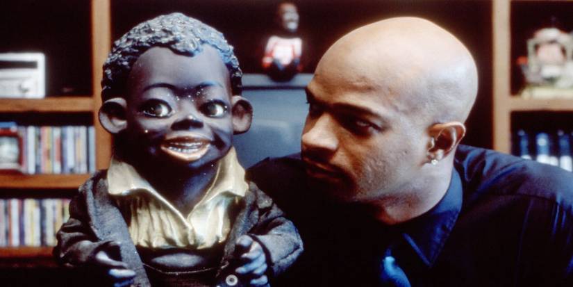 Damon Wayans looking at a black antique in Bamboozled.