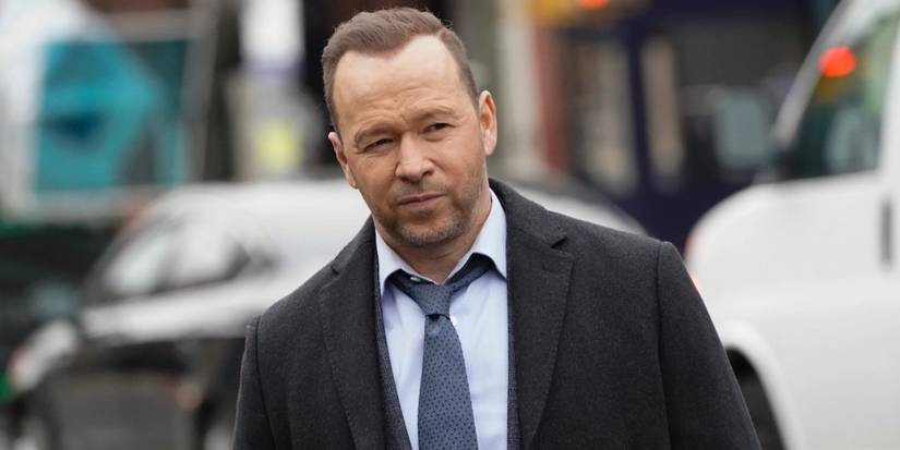 Donnie Wahlberg in 'Blue Bloods' in a suit in front of cars