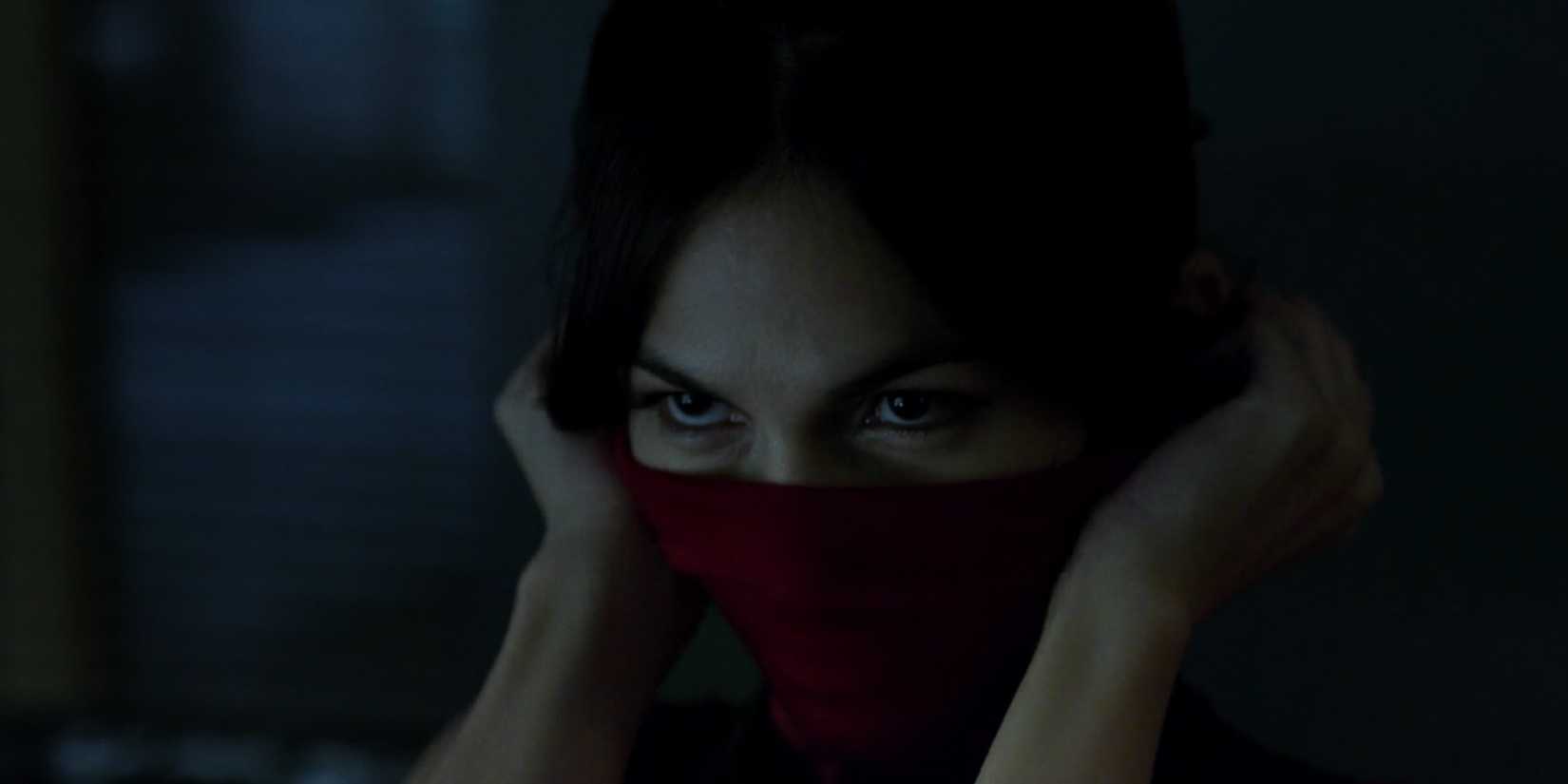 Élodie Yung as Elektra Natchios putting on a mask in 'Daredevil.'