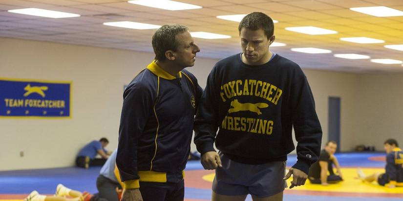 Steve Carell as John du Pont coaching Channing Tatum as Mark Schultz in Foxcatcher.