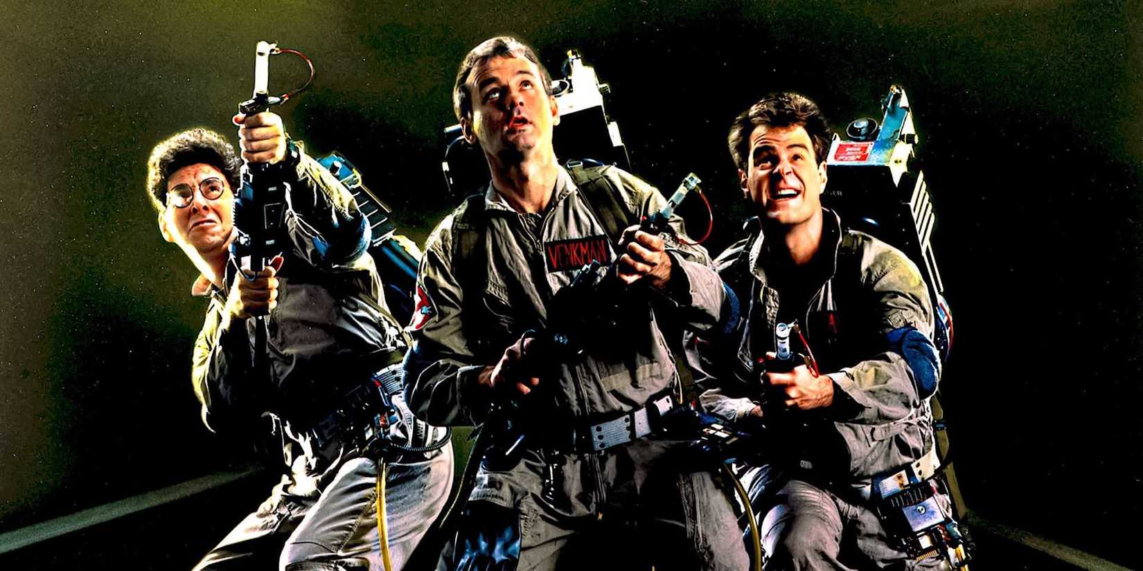 Three of the Ghostbusters wear their proton packs and look up in Ghostbusters.