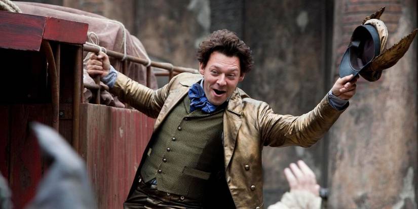 A mailman hangs off the side of a car in 'Going Postal' 