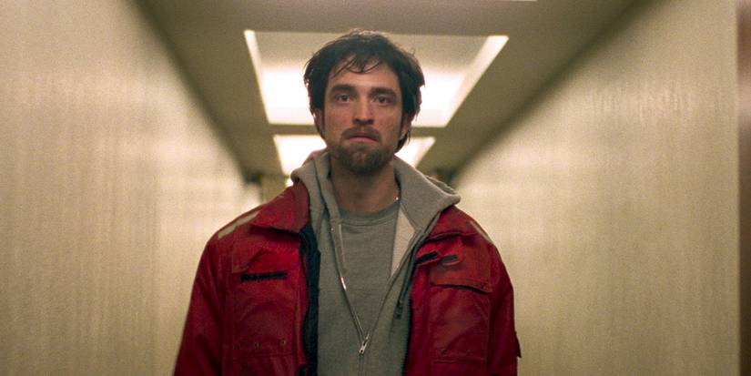 Robert Pattinson walking down a hallway in Good Time