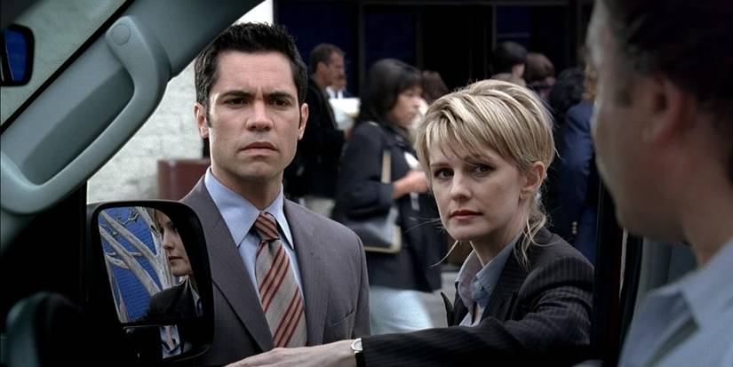 Danny Pino as Scotty Valens and Kathryn Morris as Lilly Rush talk to someone in a car in 'Cold Case.'