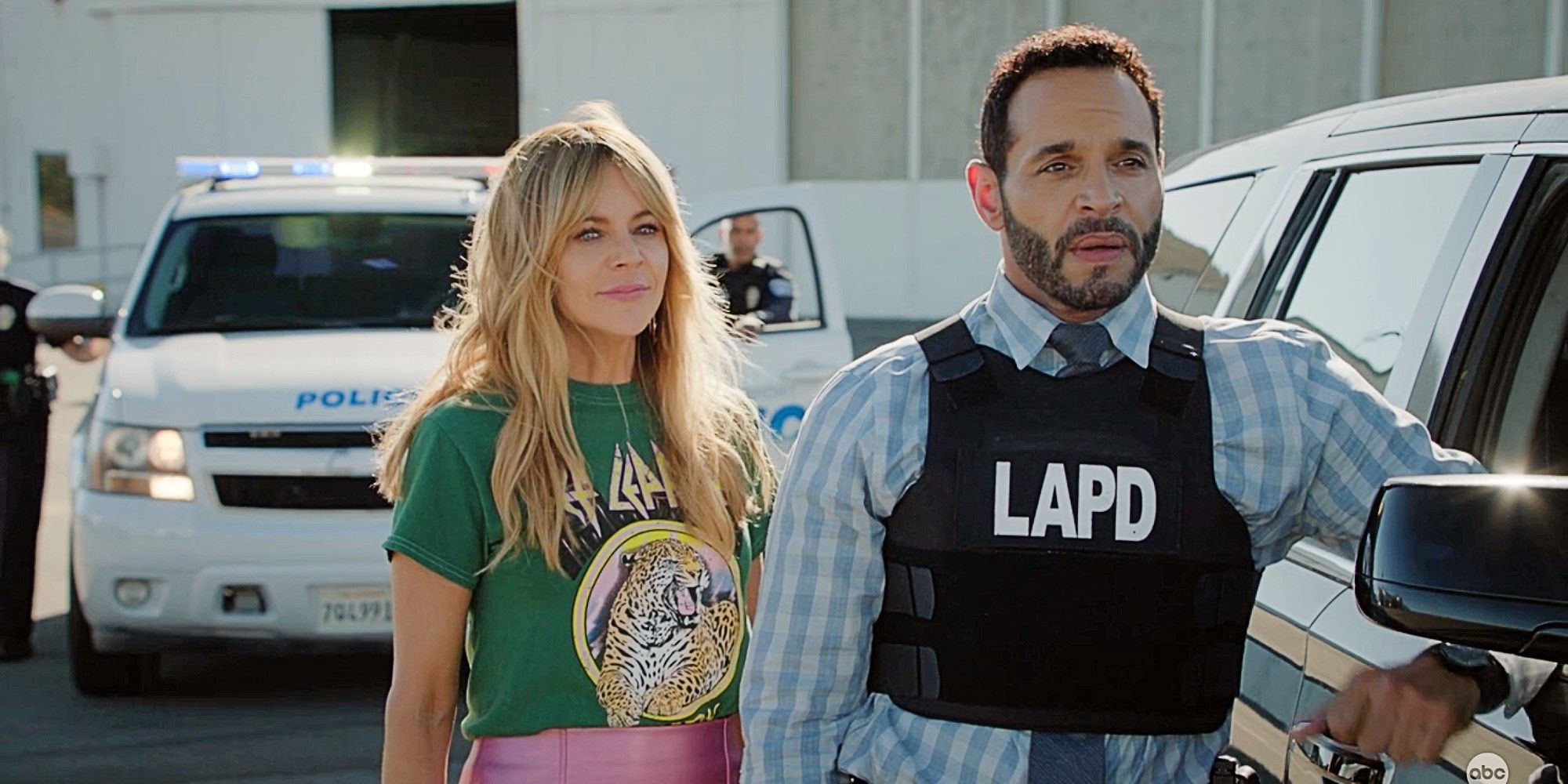 Morgan Gillory and Adam Karadec standing together while on duty in High Potential Season 1 Episode 11. Karadec is wearing a bulletproof vest with LAPD printed on it..