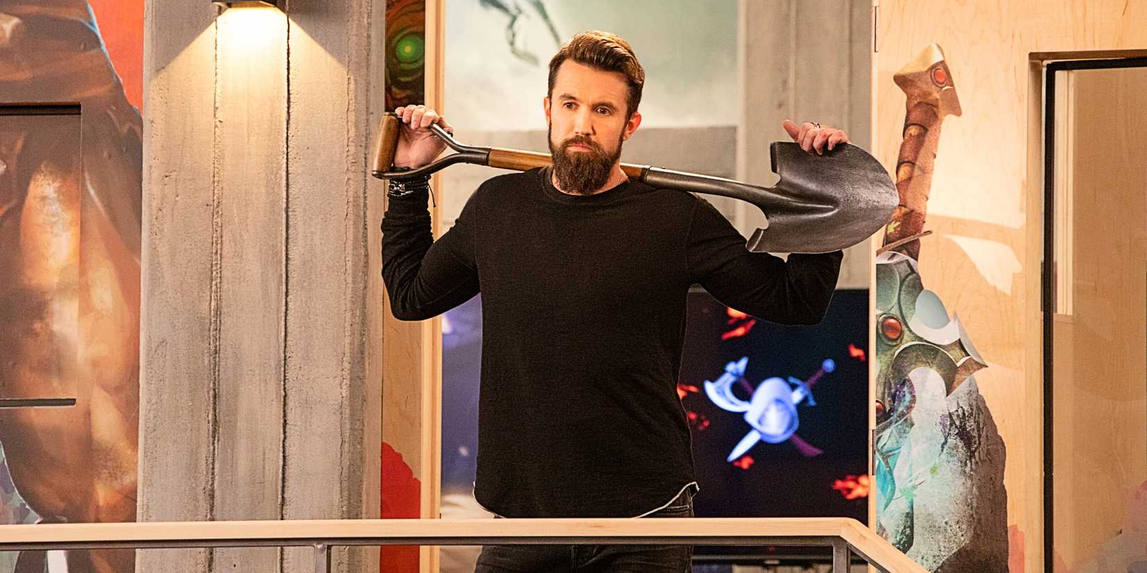 Rob McElhenney as Ian Grimm holding up a shovel in the pilot episode of Mythic Quest.