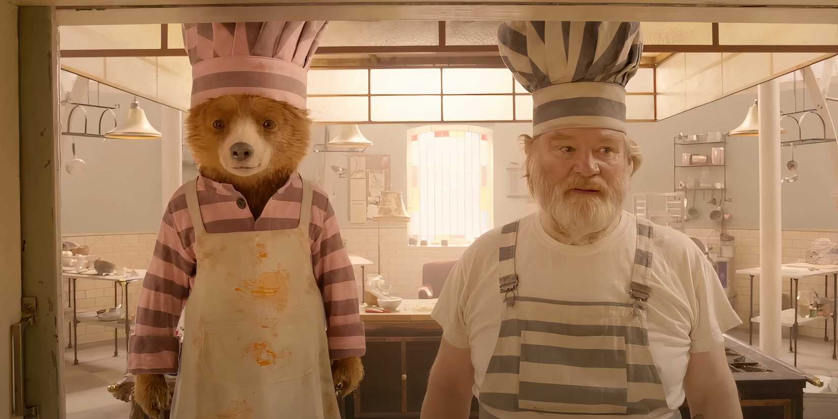 Paddington (Ben Whishaw) and Knuckles (Brendan Gleeson) look on in 'Paddington 2' (2017)