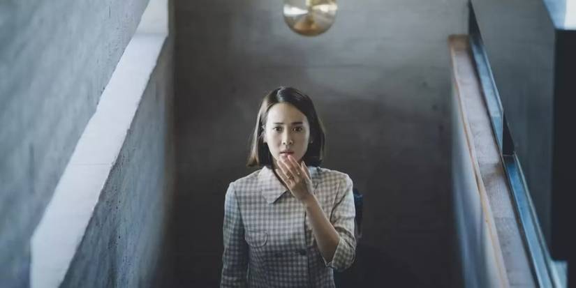 Cho Yeon-jo climbs a staircase in a scene from Parasite.