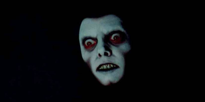 Pazuzu's intimidating face looking down from the darkness in The Exorcist