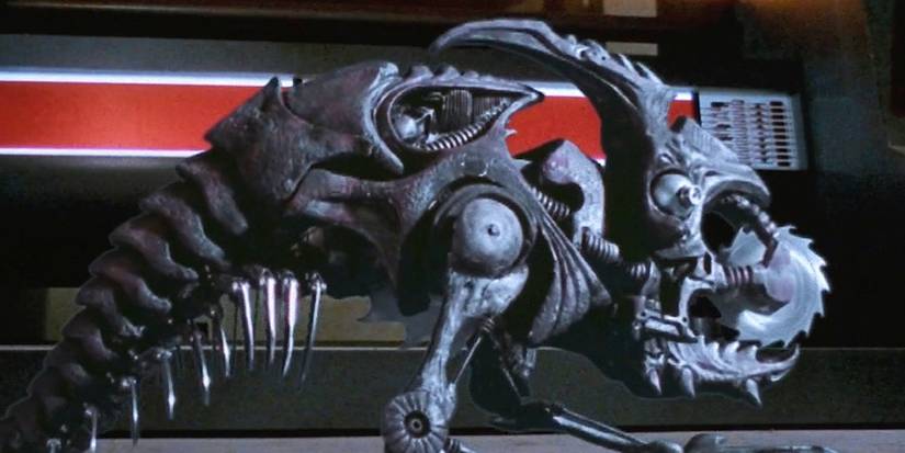 A small robotic creature on two legs with a long, skeletal tail and a saw blade in its mouth from Screamers.
