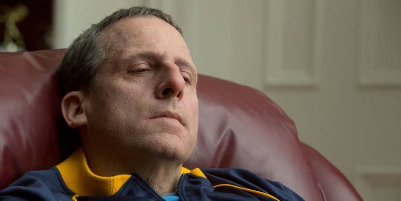Steve Carell as John du Pont looking pensive in Foxcatcher.