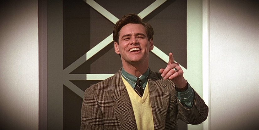 jim carrey smiles and points at the camera in Truman Show