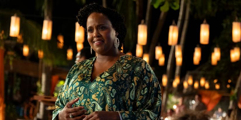 Natasha Rothwell as Belinda at an outdoor party in The White Lotus Season 3, Episode 3. 