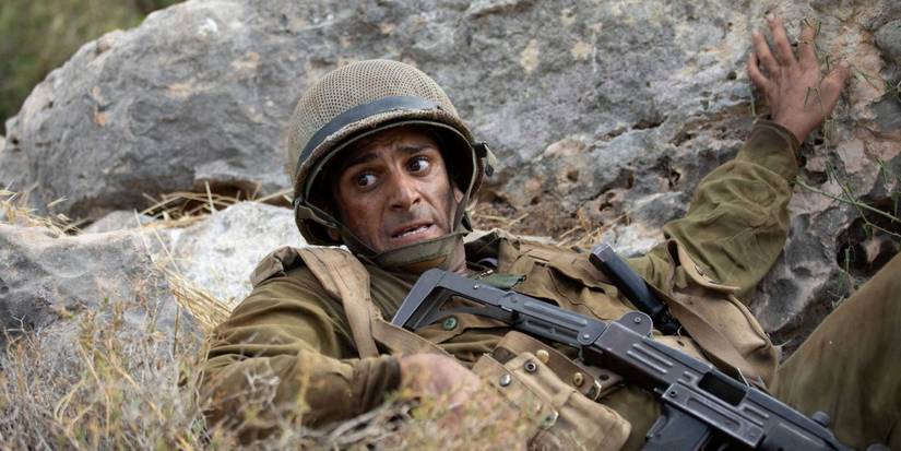 A soldier takes cover behind rocks in 'Valley of Tears'
