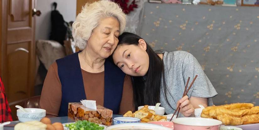 Billi leaning her head on her grandmother's shoulder in The Farewell