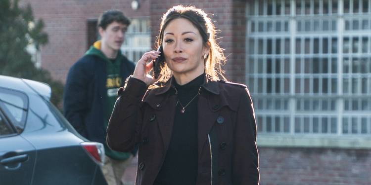 Reenie Green (Fiona Rene) with a cell phone in hand on 'Tracker.'