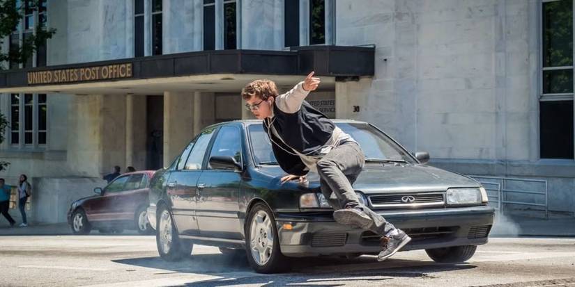 Baby slides over a car while running away in Baby Driver.