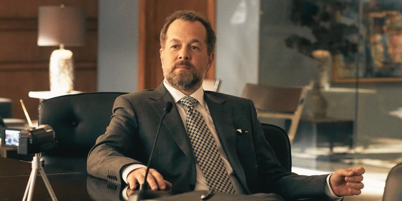 David Costabile as Daniel Hardman seated at a conference table during a legal deposition in 'Suits'