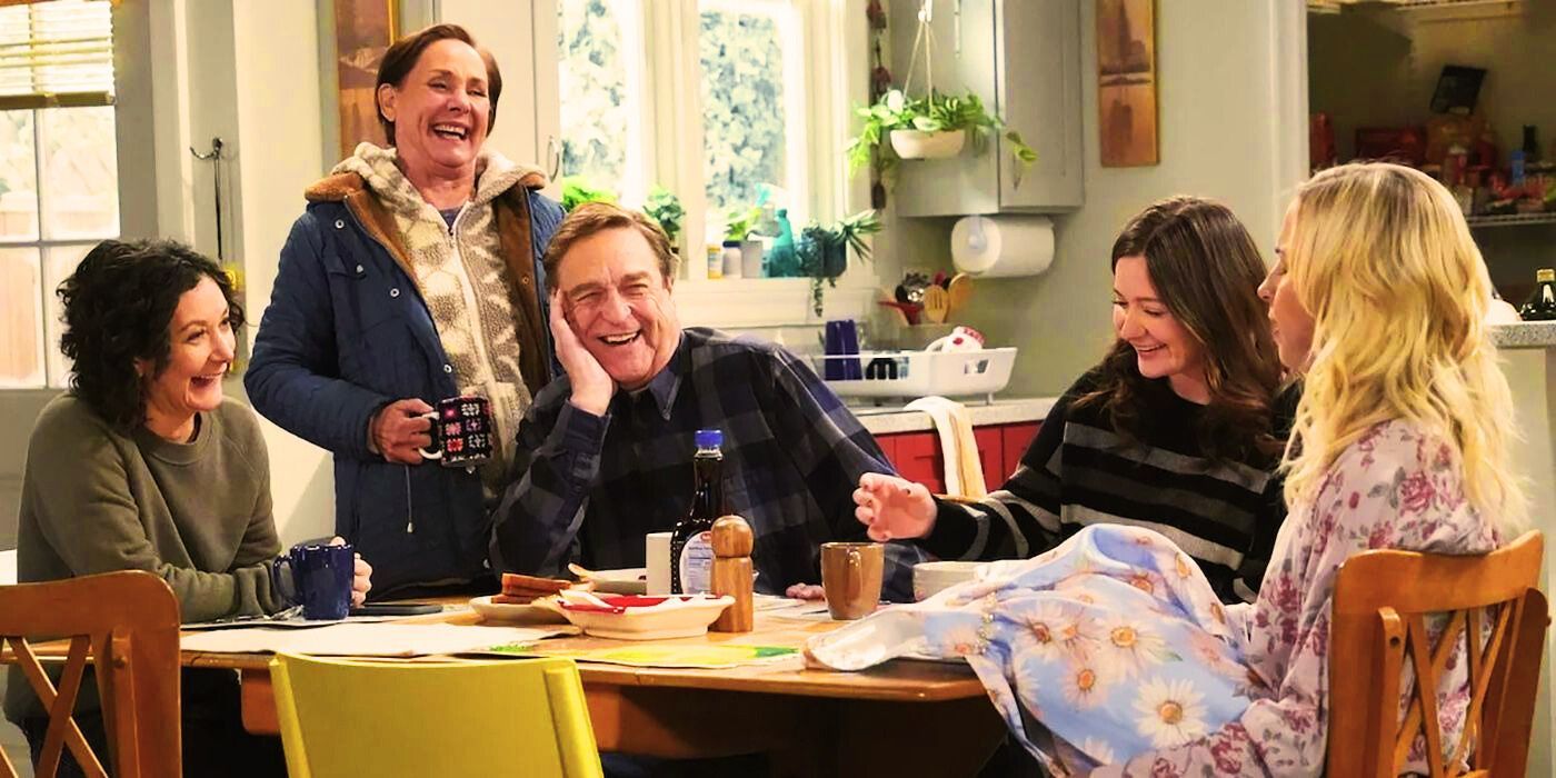 Darlene, Jackie, Dan, Harris, and Becky sitting around a kitchen table smiling and laughing on The Conners.