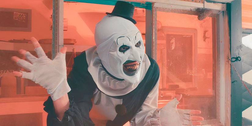 Art the Clown appears at the window of the clown cafe in Terrifier 2.
